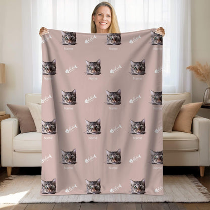 Person holding a blanket with cat pattern in a living room