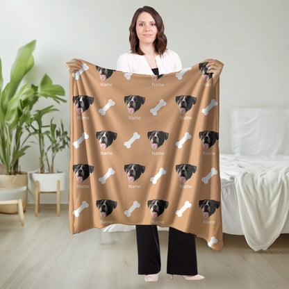 Person holding a brown blanket with dog faces and bones pattern in a room.