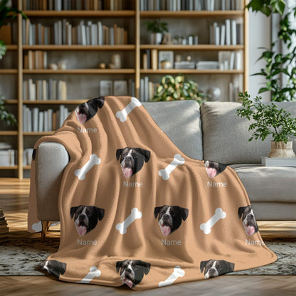 Blanket with dog faces and bones pattern on a couch in a living room setting