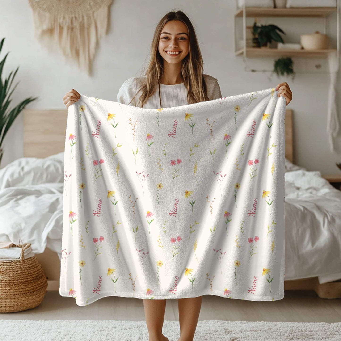 Woman holding a white blanket with floral patterns in a bedroom setting